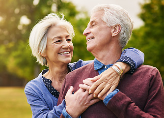 Image showing Old couple hug, smile in the park and happiness together outdoor, bonding in nature with love and retirement. Happy, man and woman with travel, relationship with trust in marriage and commitment