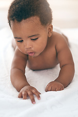 Image showing Girl, lying and kids with a black baby in a home, towel on the floor for growth or child development. Relax, children and family home with a newborn infant playing in the living room of a house