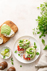 Image showing Avocado toast with cheese cottage, tomato and herbs for breakfast