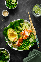 Image showing Salmon avocado bowl with broccoli, green peas, rice and fresh salad. Healthy food, top view