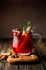 Image showing Christmas mulled wine with cranberry, orange, cinnamon, anise and rosemary. Traditional hot drink or beverage, festive Xmas or New Year winter cocktail