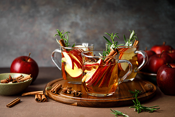 Image showing Christmas mulled apple cider with cinnamon, anise and rosemary. Traditional hot drink or beverage, festive Xmas or New Year winter cocktail