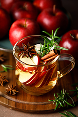 Image showing Christmas mulled apple cider with cinnamon, anise and rosemary. Traditional hot drink or beverage, festive Xmas or New Year winter cocktail