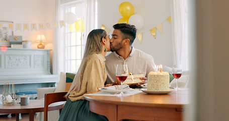 Image showing Couple, kiss and gift for birthday celebration, love and happy relationship together at home. Man and woman celebrating special day of birth in bonding happiness with cake and gifts at the table