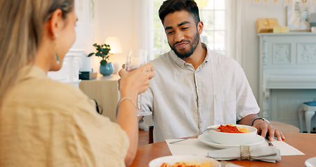 Image showing Toast, love and couple on a wine date in a house in celebration of a happy marriage and anniversary. Smile, romance and young woman drinking alcohol and eating spaghetti food with a romantic partner