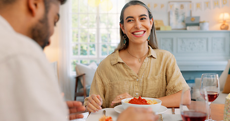 Image showing Lunch, happy and couple eating pasta together at a dining room table in their house. Happy, relax and calm man feeding a comic woman food during a dinner date in their home for love and peace