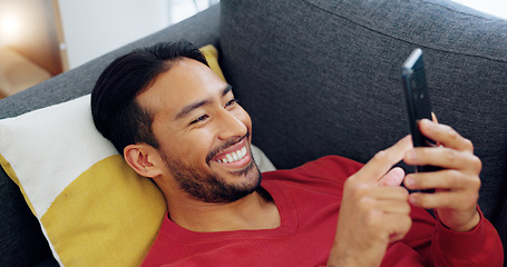 Image showing Sofa, happy and relax man with phone scroll, browse or search social media app for comedy or funny meme. Person lounge on living room couch with happiness, mobile smartphone and reading online comic