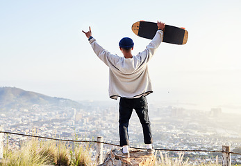 Image showing Skateboard, freedom and mountains with man cheering for fitness, sports and adventure. Happiness, commitment and training with gen z guy skating in outdoors for travel, wellness and summer break