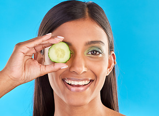 Image showing Skincare, beauty and portrait of Indian woman with cucumber, makeup and facial detox with smile on blue background. Health, wellness and sustainability, organic luxurycleaning and grooming cosmetic