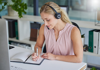 Image showing Woman, call center and writing in notebook by office desk for record keeping, reminder or planning. Happy female consultant taking notes in book for customer service, support or idea to schedule task