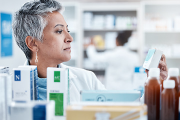 Image showing Senior woman, pharmacist and check with box, medicine or pills by shelf in store for healthcare services. Elderly pharma expert, retail stock and medical product for mockup space, health and wellness