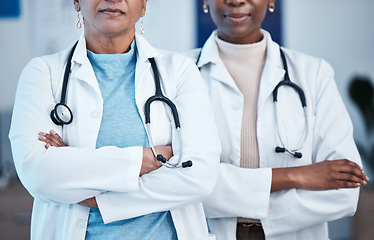 Image showing Closeup, doctors and women arms crossed, leadership and confident in hospital, serious and healthcare. Zoom, female employees and medical professional with skills, clinic and teamwork for motivation