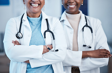 Image showing Black women, doctors and healthcare workers with happiness and solidarity in a hospital. Medical care, support and teamwork of a healthcare, wellness and health team in a clinic ready for management