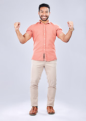 Image showing Business man, portrait and excited about winning, champion and success, cheers on studio background. Yes, fist pump and happiness with young male, professional win and promotion with bonus or reward