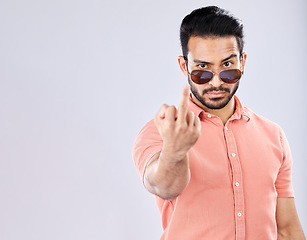 Image showing Cool, rude and portrait of an Asian man with a middle finger isolated on a grey studio background. Mockup, angry and mean guy with an offensive hand gesture, expression and space on a backdrop