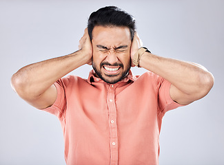 Image showing Loud, mental health and angry Asian man with schizophrenia isolated on a grey studio background. Stress, fear and scared guy closing ears for noise, scared and bipolar pressure on a backdrop