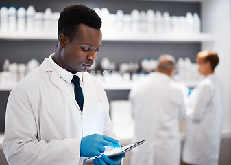 Image showing Science, black man and tablet with research, chemist and connection for typing, laboratory and focus. African American male employee, researcher and scientist with device, future or telehealth in lab