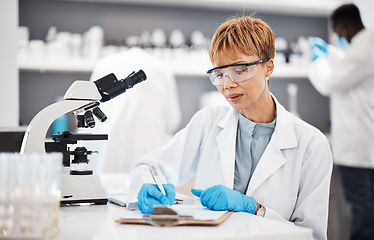 Image showing Scientist, woman and writing lab report with results, focus or analysis for pharma development. Science expert, checklist and documents with microscope, innovation and results of pharmaceutical trial