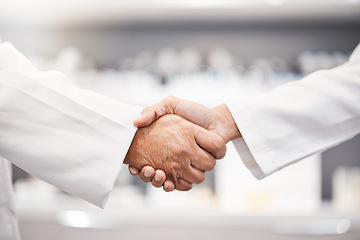 Image showing Closeup, handshake and doctors with collaboration, research and partnership for healthcare. Zoom, hand and scientists with agreements, teamwork for wellness or update for data analytics in laboratory