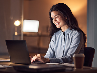 Image showing Business woman, computer typing and dark office with tax audit deadline with happiness. Corporate employee, working and happy accountant planning a online finance strategy with a laptop and a smile