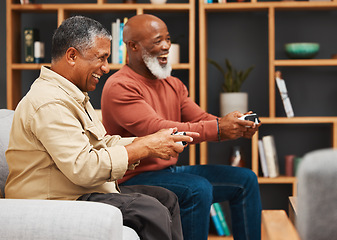 Image showing Gaming, fun and senior black man friends playing a video game together in the living room of a home. Sofa, funny or retirement with a mature male gamer and friend enjoying a house visit to game