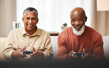 Image showing Gamer, fun and senior black man friends playing a video game together in the living room of a home. Sofa, funny or retirement with a mature male and friend gaming or bonding during a visit in a house