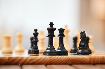 Image showing Chess, board games and black pieces on wooden table in focus with queen protecting the king in strategic match. Vintage game in problem solving for skilled players in tactics or strategy on mockup