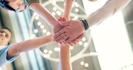 Image showing Teamwork, collaboration and low angle of business people with hands together in office. Team building, solidarity and group of employees huddle for unity, union and motivation, goals and targets.