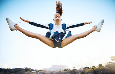Image showing Cheerleader woman, sky and sports performance with smile and energy to celebrate outdoor. Cheerleading person dance or jump stunt while laughing with joy for training workout, freedom or competition