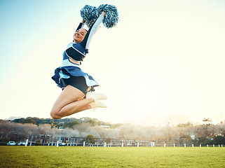 Image showing Cheerleader, woman jump to sky for sports performance or celebration with energy outdoor. Cheerleading person dance in nature with space for training, exercise and sport competition to celebrate goal