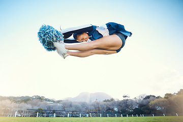 Image showing Cheerleader woman, jump and sports outdoor on blue sky for performance, energy and celebration. Cheerleading person dance or stunt for training workout, freedom or competition to support game