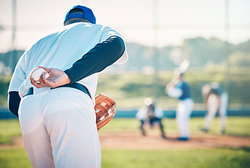 Image showing Man, baseball and pitcher ready to throw ball for game, match or victory shot on grass field at pitch. Male sports player with hand behind back with mitt in preparation for sport pitching outdoors