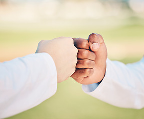 Image showing Sports, teamwork and hands for fist bump on field for motivation, support and solidarity outdoors. Thank you greeting, collaboration and hand connection for success, goals and target for competition