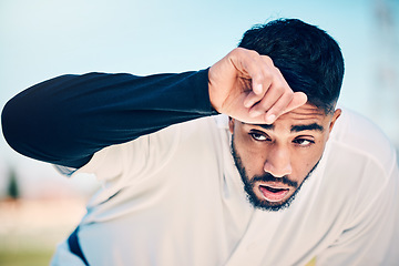 Image showing Tired, sweat and baseball man at a field for training, break and breathing after game fatigue. Athletic, sports and indian guy stop to breathe after exercise, workout or match practice