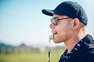 Image showing Coach, blowing whistle and sports training on a field with a man outdoor for competition or challenge. Fitness trainer or teacher person face profile for athlete game, coaching and pitch strategy