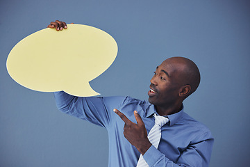 Image showing Black man, social media and mockup with speech bubble for advertising or marketing against a blue studio background. African American male pointing to shape for voice, opinion or text advertisement
