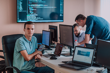 Image showing Programmers engrossed in deep collaboration, diligently working together to solve complex problems and develop innovative mobile applications with seamless functionality.