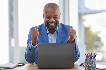 Image showing Happy black man, laptop and celebration for winning, sale or good news on discount at the office desk. Excited African American male celebrating on computer for promotion, bonus or achievement