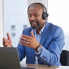 Image showing Black man, laptop and video call consulting with headset at office desk for telemarketing, customer service or support. African man working on computer explaining business proposal in call center
