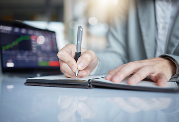 Image showing Trader, hands and writing notes in book on stock market chart or graph statistics for trading at the office. Hand of investor or broker taking note of bitcoin, cryptocurrency or investment for profit