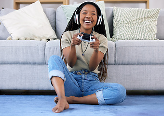 Image showing Black woman, gaming and smile with controller by living room sofa for fun match or online game at home. Happy African American female playing video games with headphones for entertainment or esports