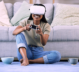 Image showing Video games, black woman and virtual reality headset on home floor for online gaming, ar and relax. Gamer person with console for metaverse, esports and cyber or 3d digital world with futuristic tech