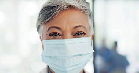 Image showing Covid, face mask and senior doctor in hospital for healthcare, safety or wellness. Leadership, corona or portrait of female, woman or medical physician in ppe prepared to tackle the covid 19 pandemic