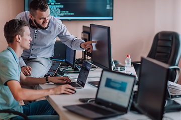 Image showing Programmers engrossed in deep collaboration, diligently working together to solve complex problems and develop innovative mobile applications with seamless functionality.