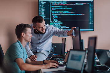 Image showing Programmers engrossed in deep collaboration, diligently working together to solve complex problems and develop innovative mobile applications with seamless functionality.