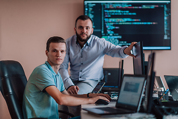 Image showing Programmers engrossed in deep collaboration, diligently working together to solve complex problems and develop innovative mobile applications with seamless functionality.