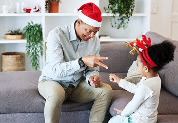 Image showing Rock, paper, scissors at Christmas with a father and daughter in the living room of their home together. Black family, love or bonding with a man and girl child playing games in their house