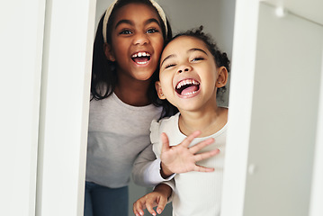 Image showing Girl children, door and surprise game with bonding, smile and playful in family home with sisters. African female kids, happy and holiday with love, comic time and funny joke for scare in bedroom