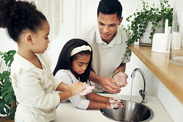 Image showing Dad, kids and washing hands in bathroom with soap at tap teaching girls hygiene on morning routine. Water, soap and man with children cleaning dirt, bacteria and germs for health, care and wellness.