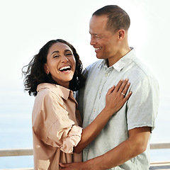 Image showing Portrait, laughing and senior couple by beach, hug and enjoying quality time on holiday or vacation. Love, comic and retired happy man and woman laugh at funny joke or comedy while having fun by sea.